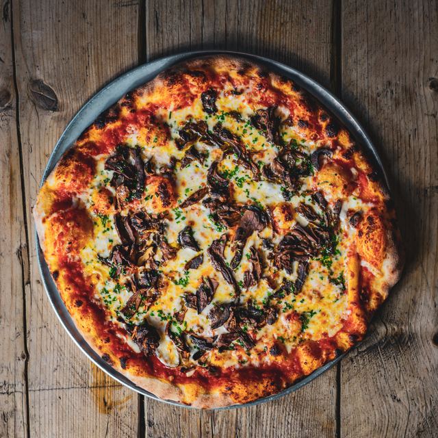 A New York pizza with porcini and chives, from above