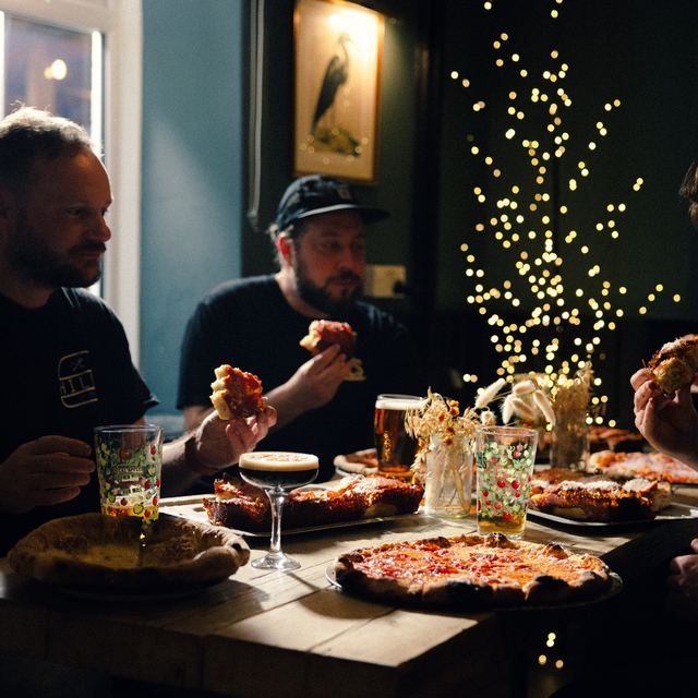 Both pizza styles on one table inside the pub