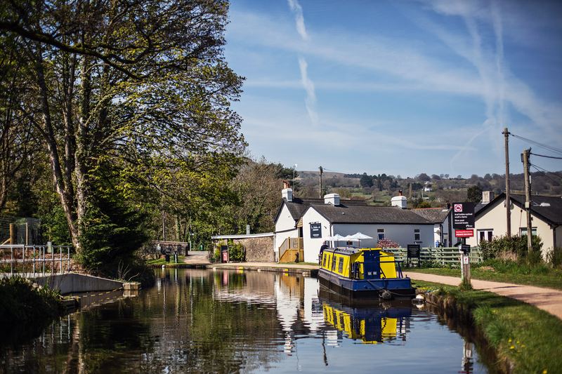 The Towpath Inn beside the Monmouthshire and Brecon Canal, a narrowboat moored in front